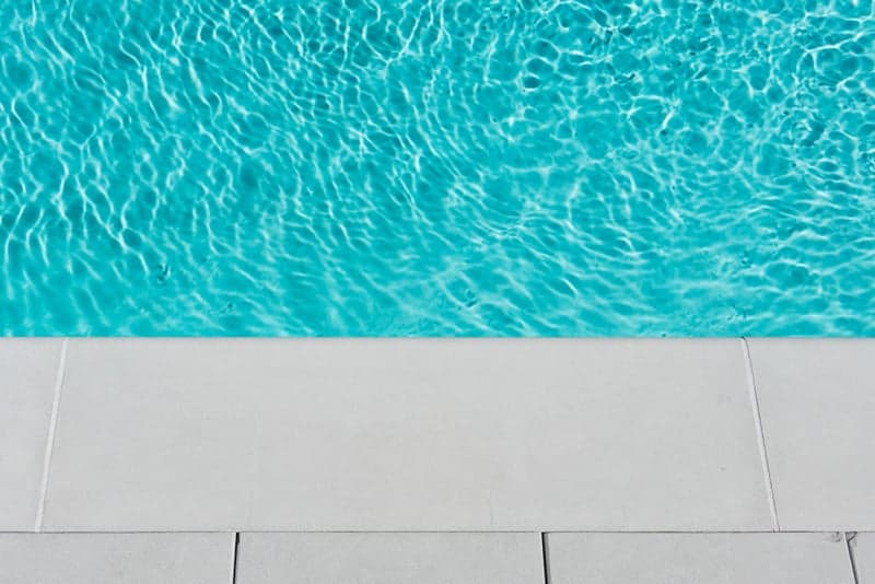 Crystal-clear pool water with sunlight reflections